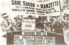 Newspaper clipping of protesters holding up signs during the Sacco and Vanzetti demonstrations, Boston, MA.